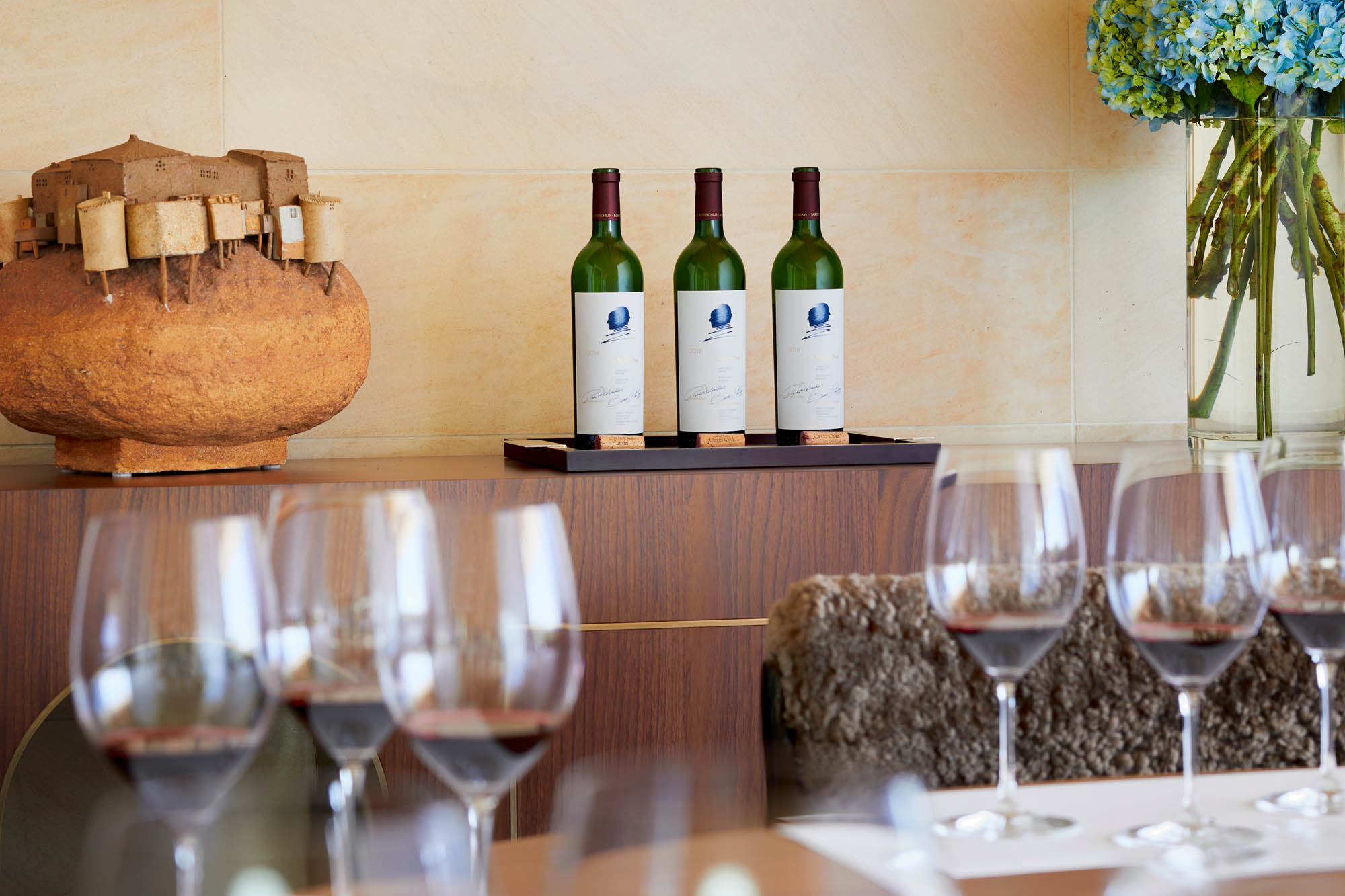 Opus One Wine Bottles behind wine glasses