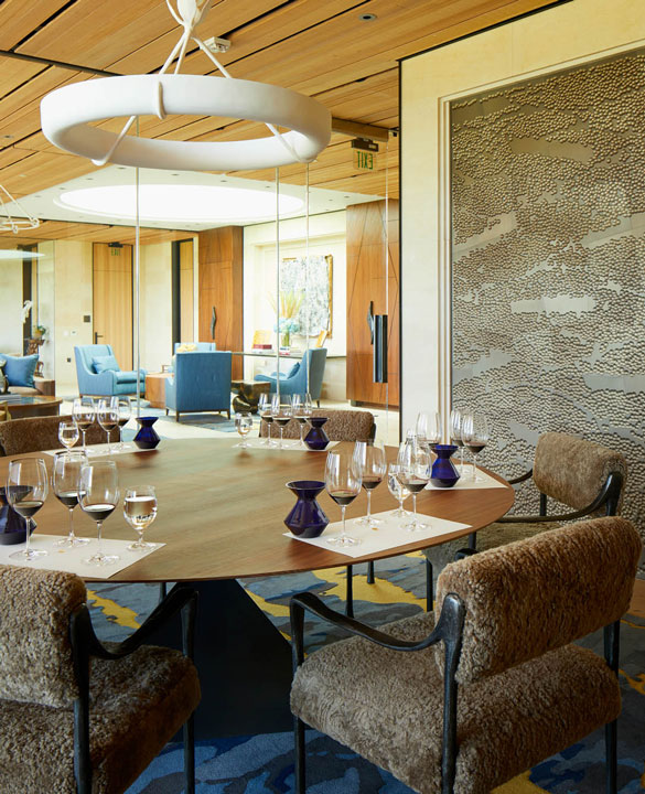 A private room in the new Partners' Room with a large round table, and a tasting set up with wine glasses for five guests