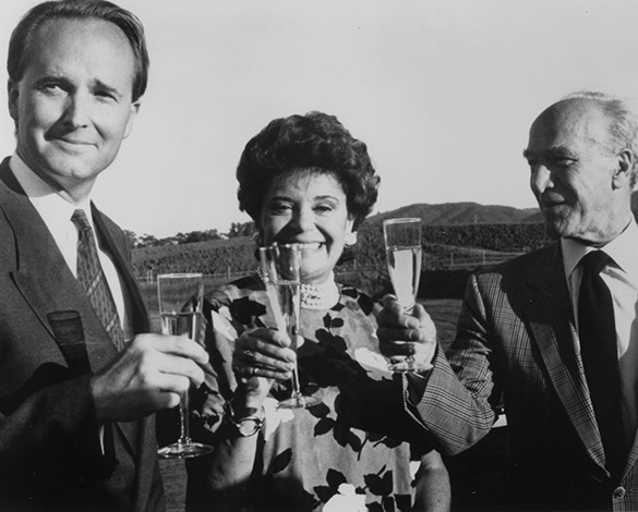 Architect Scott Johnson of Johnson Fain (left), Baroness Philippine de Rothschild (center), and Robert Mondavi (right) toast the new Opus One Winery at its groundbreaking ceremony in October 1989.